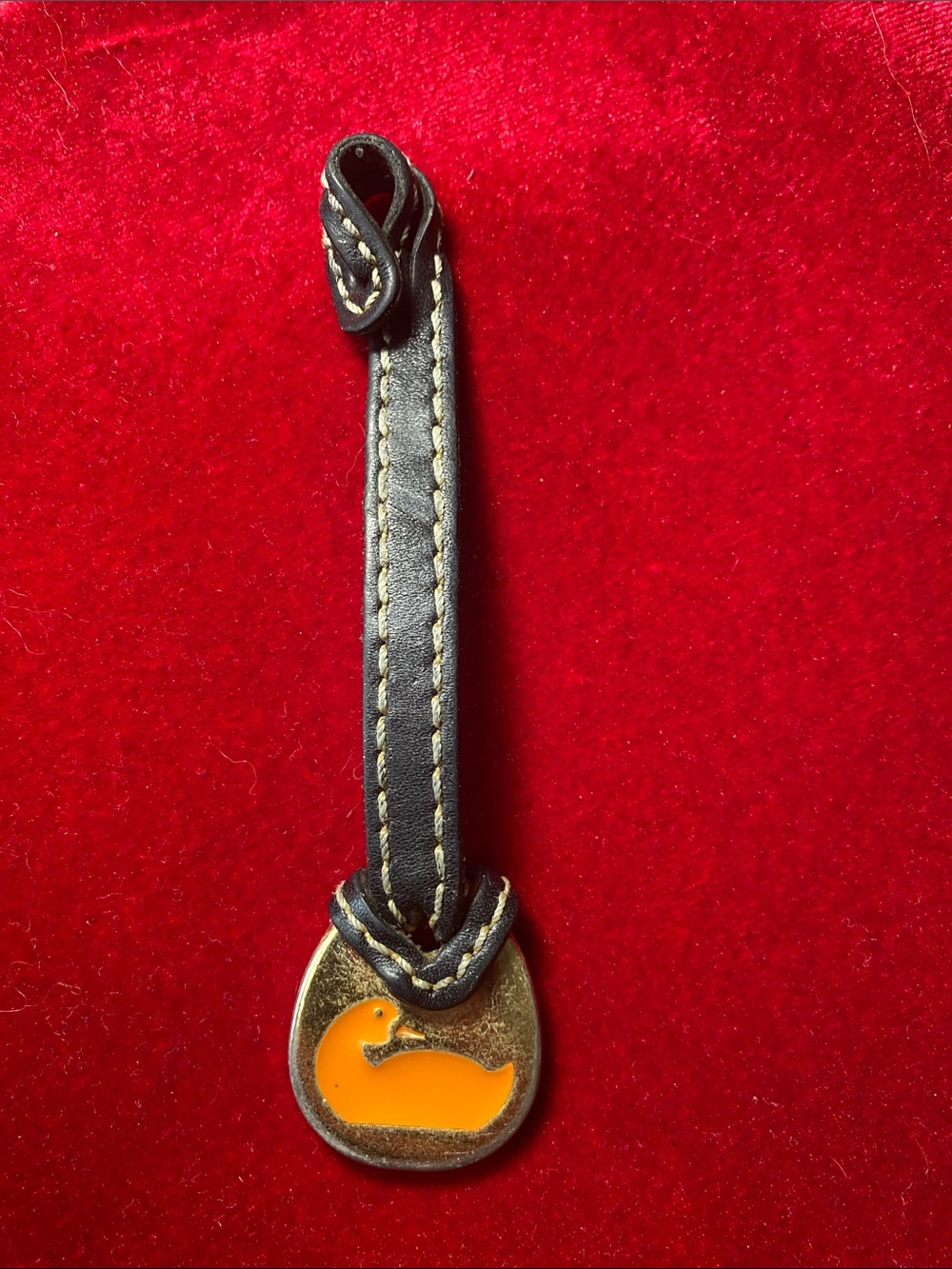 Dooney & Bourke Black Leather Wrist Strap with Orange Duck Charm